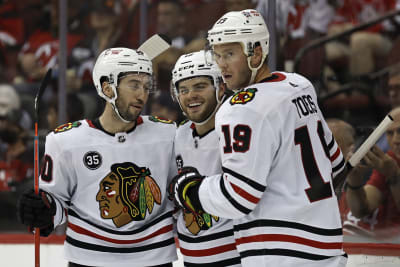 Chicago Blackhawks center Kirby Dach, right, celebrates his tying