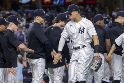 Marwin Gonzalez of the New York Yankees flips the ball to Ron