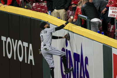 Chicago White Sox Billy Hamilton climbs the outfield wall to give