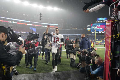 Tampa Bay Buccaneers quarterback Tom Brady (12) puts on his helmet during  the second half of an NFL football game against the New England Patriots,  Sunday, Oct. 3, 2021, in Foxborough, Mass. (