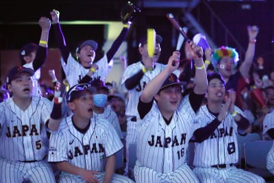 Munetaka Murakami of Team Japan reacts to hitting a walk off two