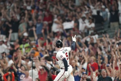 Atlanta Braves' Ronald Acuna Jr., right, high-five Freddie Freeman after  hitting a home run during the third inning of the team's baseball game  against the Miami Marlins on Wednesday, April 14, 2021