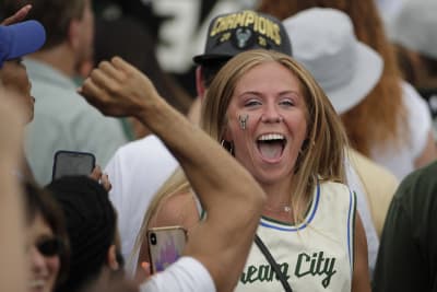 Milwaukee Bucks' Giannis Antetokounmpo holds up the NBA Championship trophy  and Finals MVP trophy to the crowd during a parade celebrating the  Milwaukee Bucks' NBA Championship basketball team Thursday, July 22, 2021