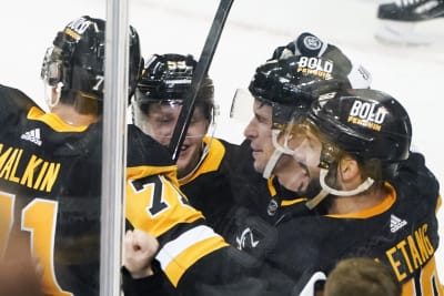 Pittsburgh Penguins' Dominik Simon, left, celebrates a goal by