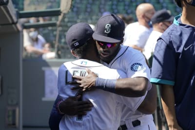 Seattle Mariners' Mitch Haniger, right, is greeted by Ty France