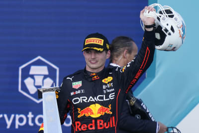 Miami Gardens, Florida, May 8, 2022. Dutch Formula One driver Max  Verstappen of Red Bull Racing holds a Miami Dolphins helmet signed by Dan  Marino and the first place trophy during the