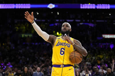 LeBron James makes history as Warriors edge Lakers 117-115