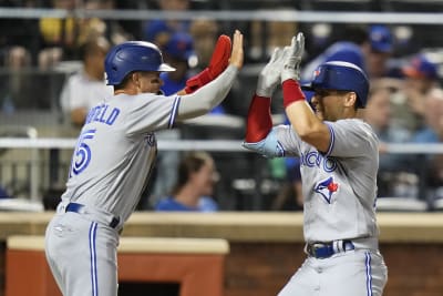 Toronto Blue Jays' Whit Merrifield, left, celebrates with third