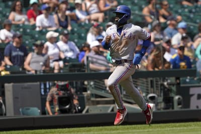 Texas Rangers' Adolis Garcia heads to first after drawing a walk