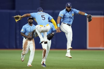 Brandon Lowe of the Tampa Bay Rays celebrates with teammates Randy