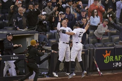 From left, New York Yankees' Anthony Rizzo, Aaron Judge and Giancarlo  Stanton celebrate in the locker room after the Yankees defeated Cleveland  Guardians in Game 5 of an American League Division baseball