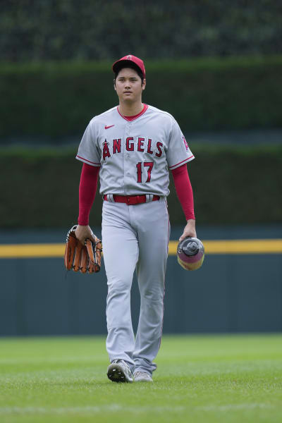 Shohei Ohtani of the Los Angeles Angels celebrates wearing a samurai  warrior helmet in the dugout after hitting a two-run home run in the third  inning of a baseball game against the