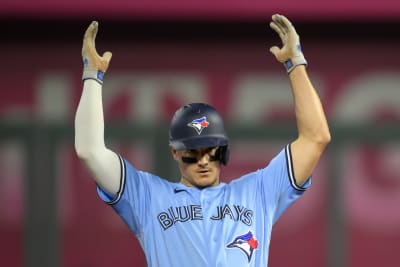 Toronto Blue Jays' Whit Merrifield, left, celebrates with third