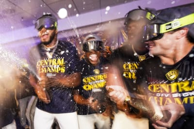 Milwaukee Brewers' owner Mark Attanasio and wife Debbie celebrate with  broadcaster Bob Uecker after clinching the National League Central Division  after a baseball game against the St. Louis Cardinals Tuesday, Sept. 26