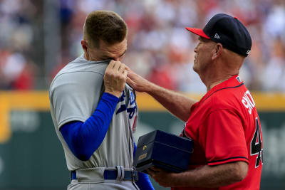 Atlanta Braves manager Brian Snitker, left, talks with a fan