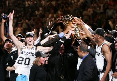 The San Antonio Spurs celebrate with the Larry O'Brien trophy