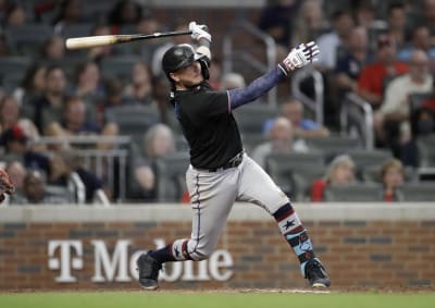 Atlanta Braves' Ronald Acuna Jr., right, high-five Freddie Freeman after  hitting a home run during the third inning of the team's baseball game  against the Miami Marlins on Wednesday, April 14, 2021