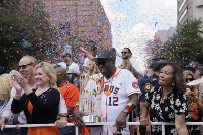 Houston Astros manager Dusty Baker Jr., right, presents a jersey to  President Joe Biden during an event celebrating the 2022 World Series  champion Houston Astros baseball team, in the East Room of