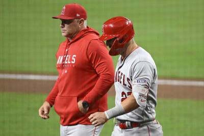 Seattle Mariners' Shohei Ohtani, left, and Mike Trout sit on the bench in  the dugout during a baseball game against the Seattle Mariners, Friday, May  31, 2019, in Seattle. The Mariners won