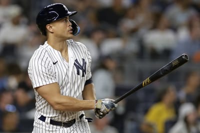 Miami Marlins center fielder Giancarlo Stanton returns to the dugout after  the second inning against the New York Yankees in their first exhibition  game at the new Marlins Ball Park April 1