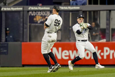 Houston Astros' Alex Bregman, left, points to a camera after hitting a home  run as catcher Christian Vazquez looks to the camera too during the eighth  inning of a baseball game against