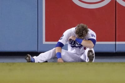 Gavin Lux of the Los Angeles Dodgers looks on from the dugout