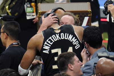 FILE - In this July 20, 2021, file photo, Milwaukee Bucks forward Giannis  Antetokounmpo holds the NBA Championship trophy, left, and Most Valuable  Player trophy after defeating the Phoenix Suns in Game