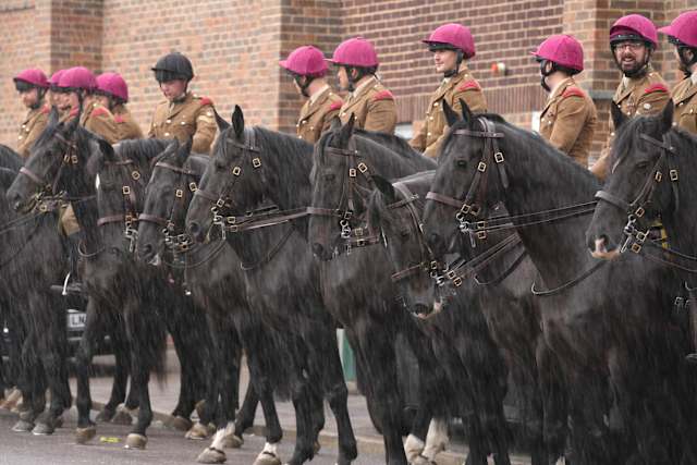 Donald Trump and British officials in ceremonial carriage