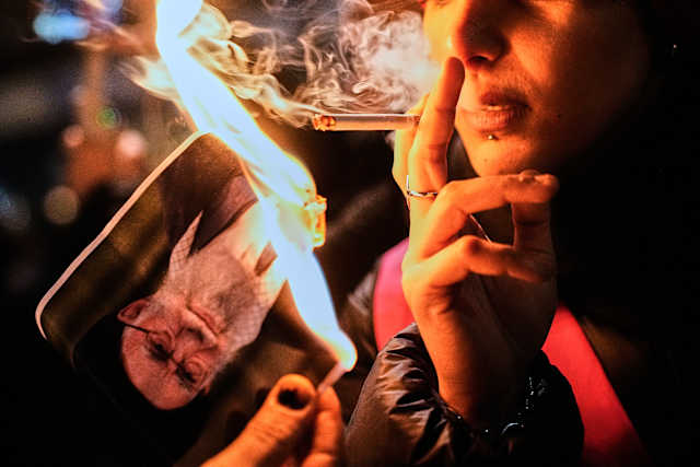 She set a photo afire, lit a cigarette — and became a symbol of resistance  for Iran protesters