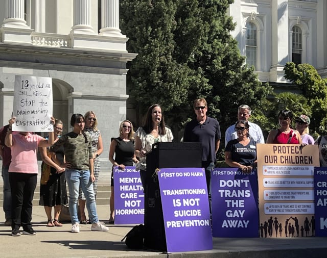 FILE - Erin Friday, a leader with Our Duty, a group supporting policies requiring school staff to notify parents if their child identifies as transgender, speaks at a rally outside of the state Capitol in Sacramento Monday, Aug. 28, 2023. A group backing a proposed ballot measure in California that would require school staff to notify parents if their child asks to change gender identification at schools is battling the attorney general in court Friday, arguing he released misleading information about the proposal to the public. (AP Photo/Sophie Austin, File)