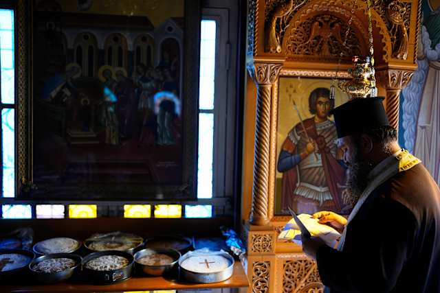 Priest Blesses Orange Fanouropita for Thousands Near Athens