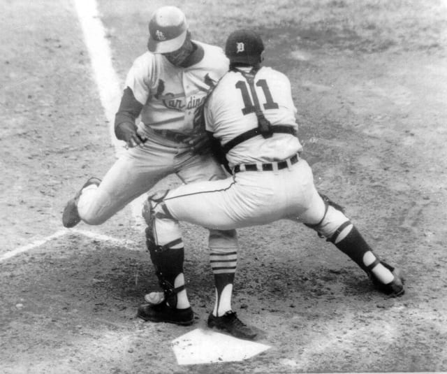 FILE - Detroit Tigers catcher Bill Freehan puts the tag on Lou Brock of the St. Louis Cardinals at the plate in the fifth inning of fifth game of World Series at Detroit's Tiger Stadium,  in this Oct. 7, 1968 file photo. Freehan, an 11-time All-Star catcher with the Detroit Tigers and key player on the 1968 World Series championship team, has died at age 79. Its with a heavy heart that all of us with the Detroit Tigers extend our condolences to the friends and family of Bill Freehan, the team said Thursday, Aug. 19, 2021. (AP Photo/File)