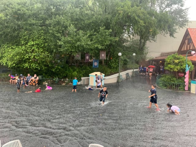 Disney guests swim in flooded Magic Kingdom streets (Credit: Cassie Claire Chase)