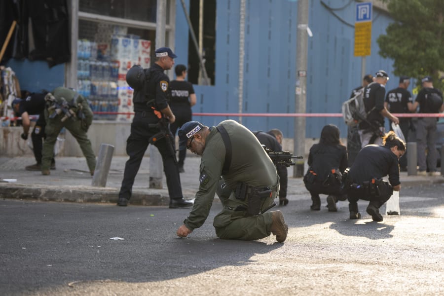 Israeli police investigate the scene of an explosive drone attack in Tel Aviv, Israel, Friday, July 19, 2024. Yemen's Houthi rebels claimed responsibility for a drone believed to have exploded above Tel Aviv early Friday morning, leaving one dead and at least 10 injured. (AP Photo/Oded Balilty)