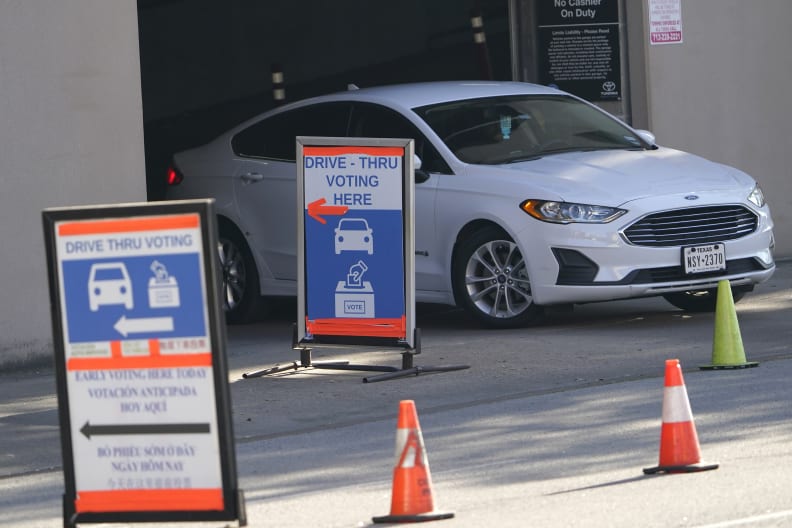 FILE In this Nov. 3, 2020, file photo a car leaves a drive-thru voting site on Election Day in Houston. As Texas moves ahead with a push to tighten voting laws, Republican lawmakers have zeroed in on Houston and surrounding Harris County. The effort is one of the clearest examples of how the GOP's nationwide campaign to impose new voting restrictions can target Democrats, even as they insist the measures are not partisan. (AP Photo/David J. Phillip, File)