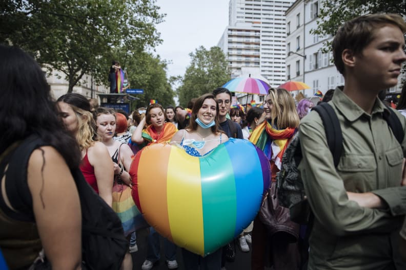 FILE - A participant holds a rainbow heart during the annual Gay Pride march in Paris, June 26, 2021. The National Assembly approved a new law unanimously Tuesday Jan. 25, 2022 evening, putting into law new measures that ban so-called conversion therapies and authorize jail time and fines for practitioners who use the scientifically discredited practice to attempt to change the sexual orientation or gender identity of LGBTQ people. The legislation includes criminal penalties for people who are convicted of trying to