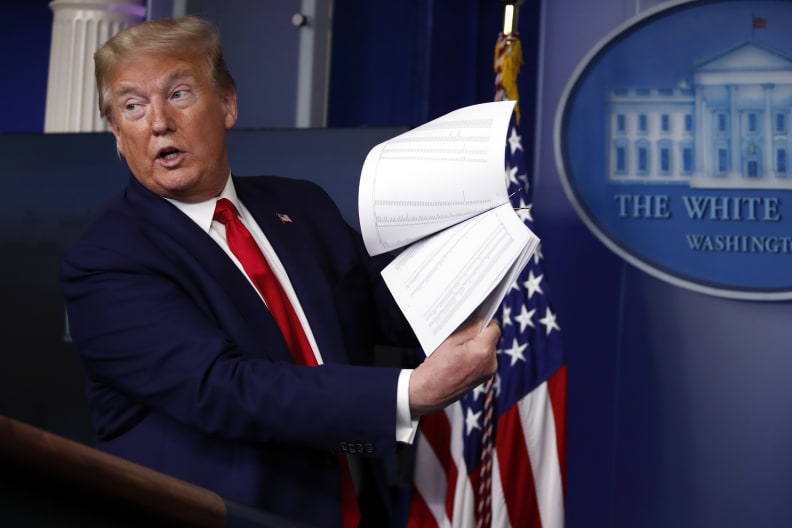 FILE - President Donald Trump holds up papers as he speaks about the coronavirus in the James Brady Press Briefing Room of the White House on April 20, 2020, in Washington. Revelations of a roughly eight-hour gap in official records of then-President Donald Trump's phone calls on the day of last year's insurrection at the U.S. Capitol are raising fresh questions about the diligence  or lack thereof  of the White House's record-keeping. (AP Photo/Alex Brandon, File)