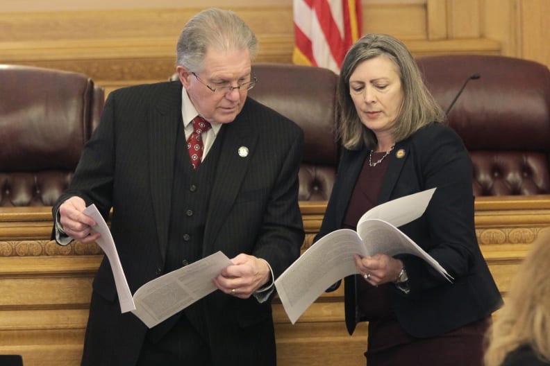 Kansas state Sen. Mike Thompson, left, R-Shawnee, confers with state Sen. Kellie Warren, R-Leawood, Wednesday, March 9, 2022, during a committee meeting at the Statehouse in Topeka, Kan. Thompson denies the link between human activity and climate change and has a key role in energy policy as the Senate Utilities Committee chairman. (AP Photo/John Hanna)