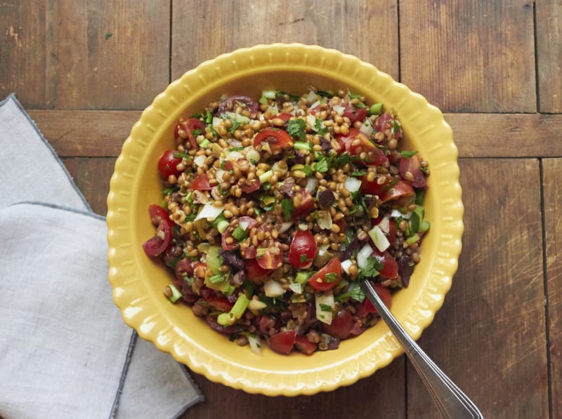 This December 2016 photo shows a Mediterranean tomato wheat berry salad with fresh herbs in New York. This dish is from a recipe by Katie Workman. (Mia via AP)