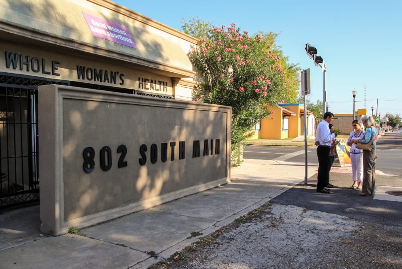 Members of the McAllen Pregnancy Center pray outside Whole Woman's Health in McAllen on Aug. 21, 2012.