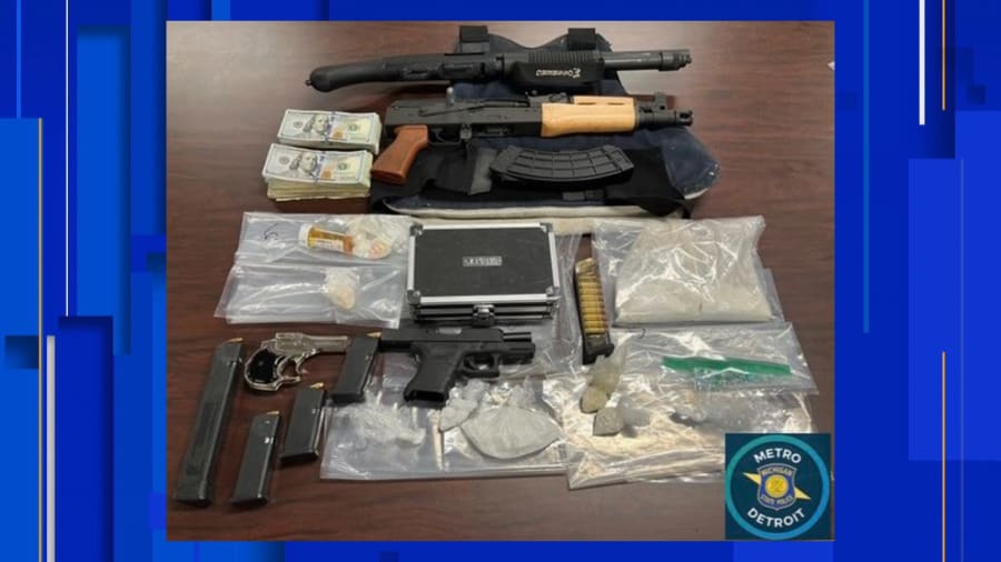 Guns, drugs, and money found during searches at two homes in Detroit.