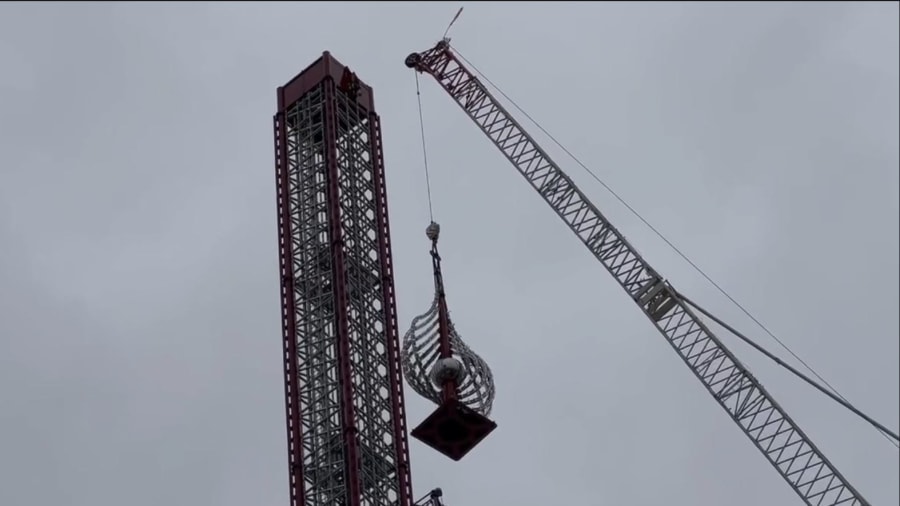 A crane removes the top of the Orlando FreeFall ride at ICON Park Wednesday.
