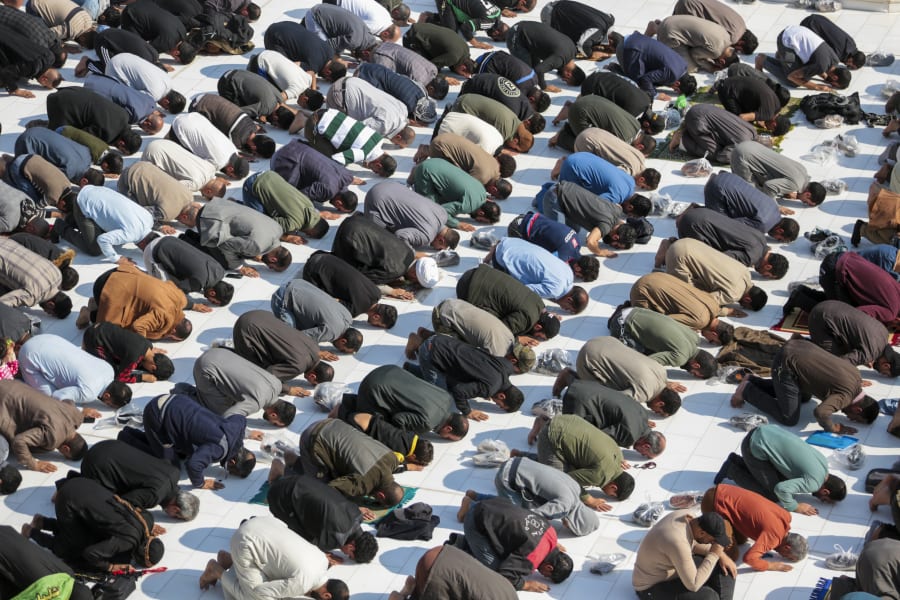 Supporters of the Shiite cleric Muqtada al-Sadr pray during Friday prayers at a mosque in Kufa, Iraq, Friday, Dec. 2, 2022. Al-Sadr who announced his withdrawal from politics four months ago has broken a period of relative silence to launch an anti-LGBTQ campaign. (AP Photo/Anmar Khalil)