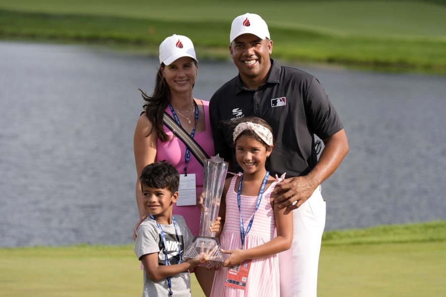 Jhonattan Vegas poses for a photo with his wife Hildegard, left, son Louis and daughter Sharlene after winning the 3M Open golf tournament at the Tournament Players Club, Sunday, July 28, 2024, in Blaine, Minn. (AP Photo/Charlie Neibergall)