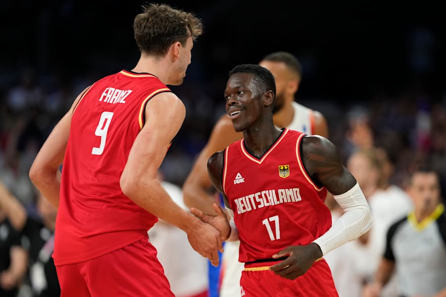 Dennis Schroder, of Germany, celebrates with Franz Wagner, after a basket against France in a men's basketball game at the 2024 Summer Olympics, Friday, Aug. 2, 2024, in Villeneuve-d'Ascq, France. (AP Photo/Mark J. Terrill)