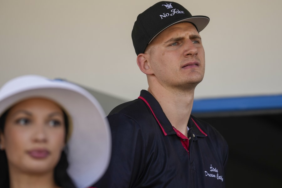 Denver Nuggets star Nikola Jokic watches a harness race at the hippodrome in the northern Serbian town of Sombor, Sunday, June 18, 2023. Jokic came to Serbia after the Denver Nuggets won the NBA Championship with a victory over the Miami Heat in Game 5 of basketball's NBA Finals. (AP Photo/Darko Vojinovic)