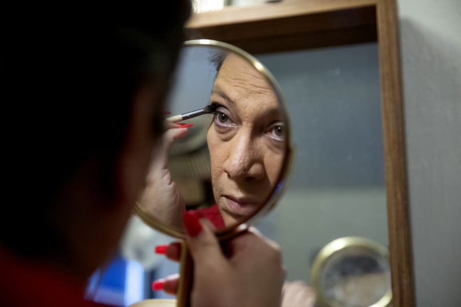 Christina Wood applies makeup and gets ready before going to work in her home in Salem, Ore., Friday, April 21, 2023. Six years ago Wood moved to Oregon, where she could access the gender-affirming health care she needed to live as her authentic self. Once there, Wood, was able to receive certain surgeries that helped her transition, but electrolysis, or permanent hair removal, wasnt fully covered under the states Medicaid plan for low-income residents. Paying out-of-pocket ate up nearly half her monthly income, but it was critical for Wood's mental health. (AP Photo/Amanda Loman)