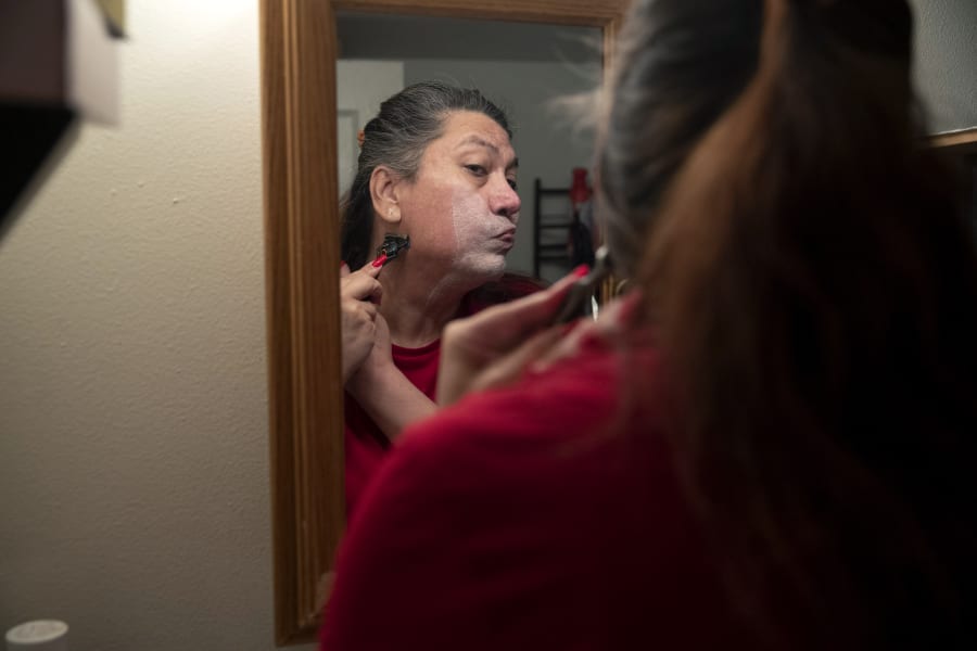 Christina Wood shaves before work in her home in Salem, Ore., Friday, April 21, 2023. Six years ago, Wood moved to Oregon, where she could access the gender-affirming health care she needed to live as her authentic self. Once there, Wood, was able to receive certain surgeries that helped her transition, but electrolysis, or permanent hair removal, wasnt fully covered under the states Medicaid plan for low-income residents. Paying out-of-pocket ate up nearly half her monthly income, but it was critical for Wood's mental health. (AP Photo/Amanda Loman)