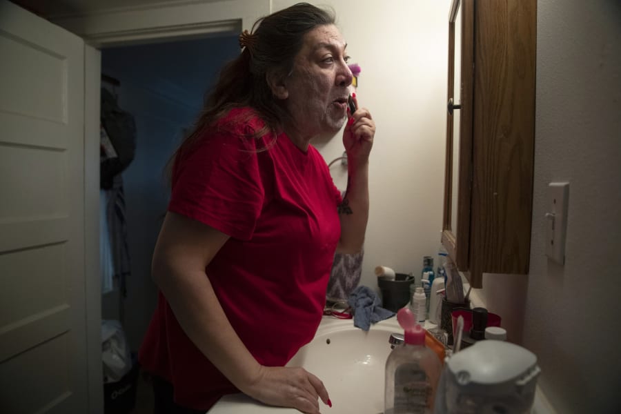 Christina Wood shaves before work in her home in Salem, Ore., Friday, April 21, 2023. Six years ago, Wood moved to Oregon, where she could access the gender-affirming health care she needed to live as her authentic self. Once there, Wood was able to receive certain surgeries that helped her transition, but electrolysis, or permanent hair removal, wasnt fully covered under the states Medicaid plan for low-income residents. Democratic lawmakers in Oregon are advancing a bill that would expand insurance coverage for gender-affirming care to include things like facial hair removal and Adams apple reduction surgery. (AP Photo/Amanda Loman)