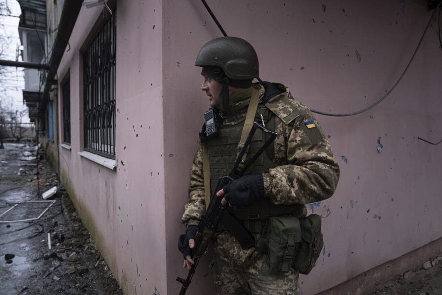 A Ukrainian marine serviceman prepares to change position during a patrol in the frontline city of Vuhledar, Ukraine, Saturday, Feb. 25, 2023. (AP Photo/Evgeniy Maloletka)